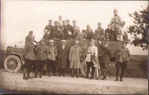 Camion militar românesc din Corpul Tracțiunii Automobile, cu cifra corpului vizibilă; ofițeri români în uniforme model 1916 și 1923