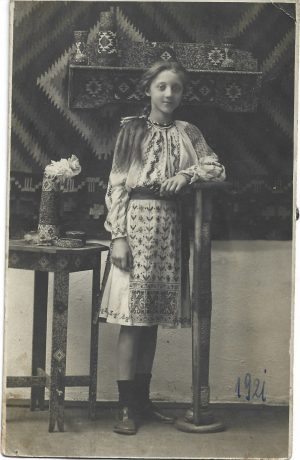 Tânără în port popular românesc, mobilă și vase în stil neoromânesc, studio Rembrandt, Iași, 1921